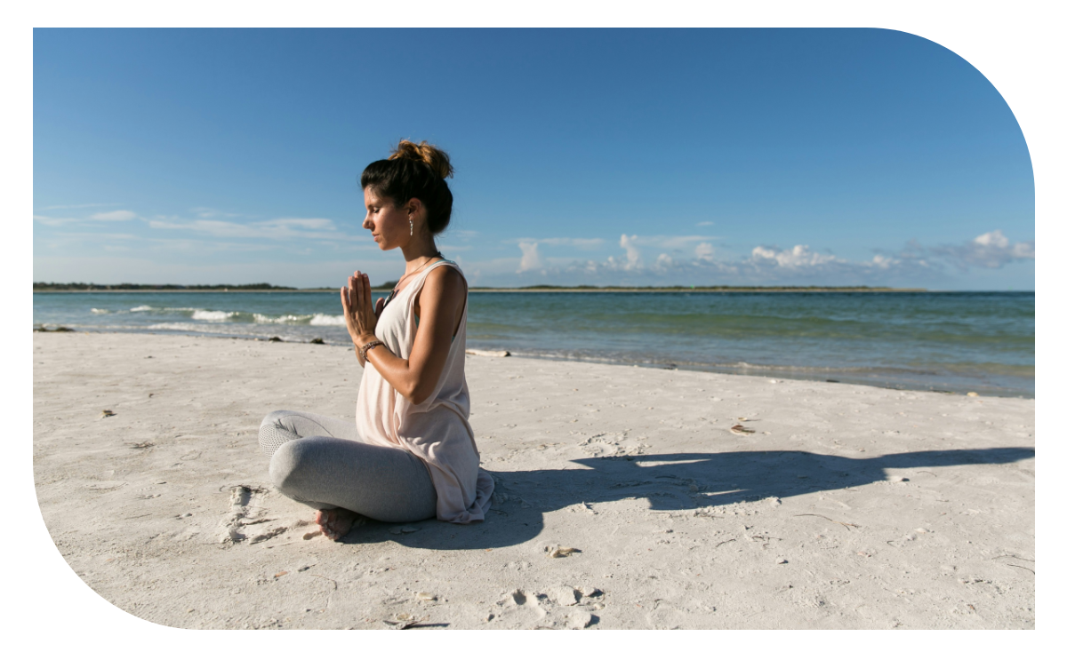 123 (14) A woman sitting on the beach in front of the ocean.