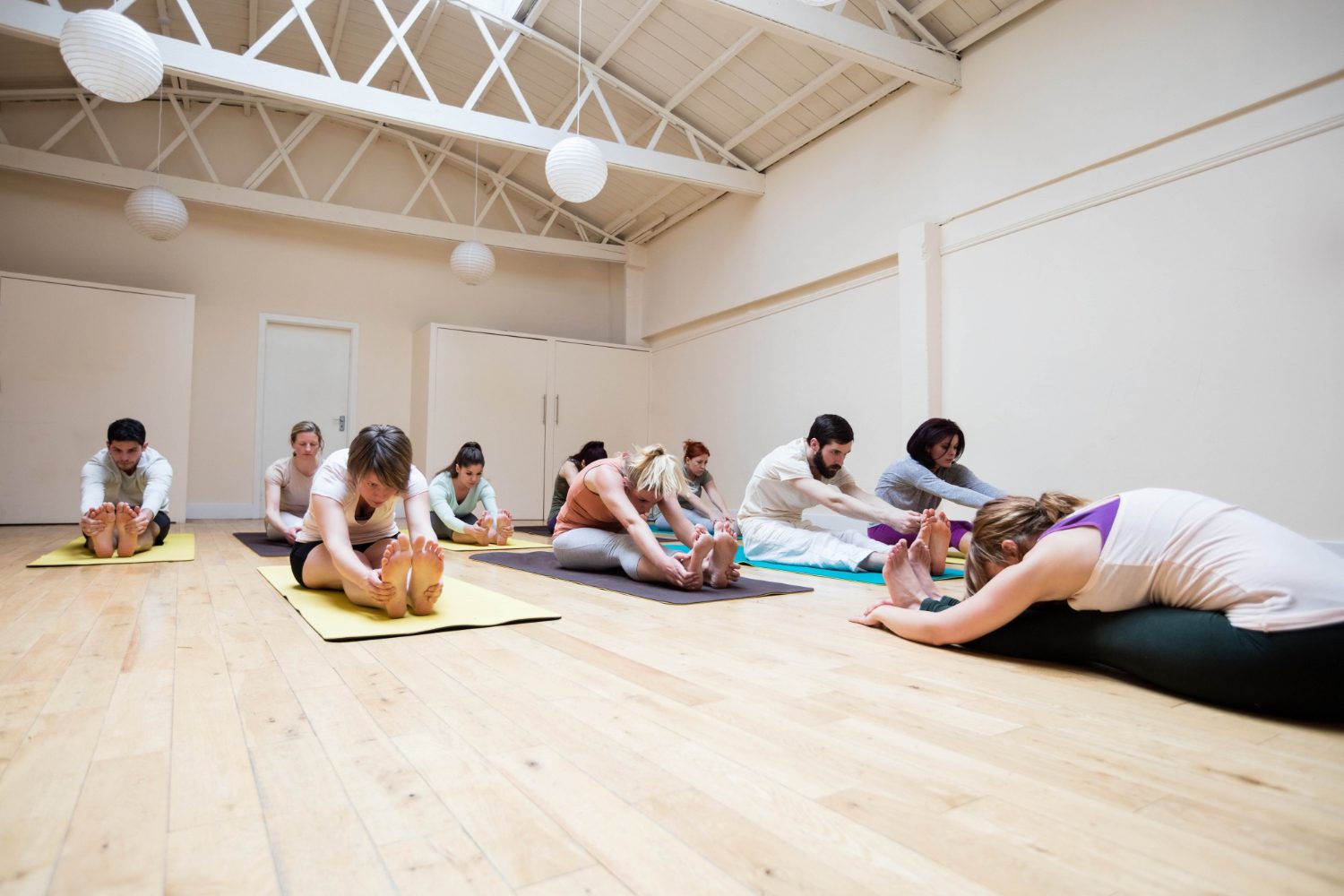 200 A group of people sitting on the floor doing yoga.