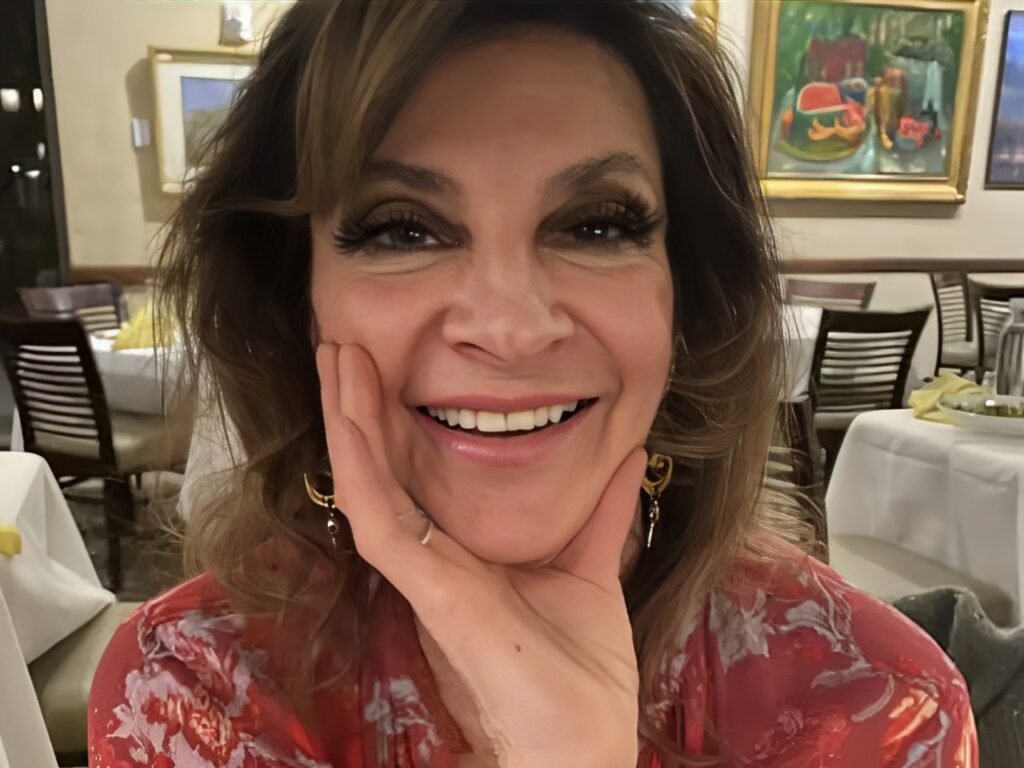 A woman with brown hair and wearing makeup.